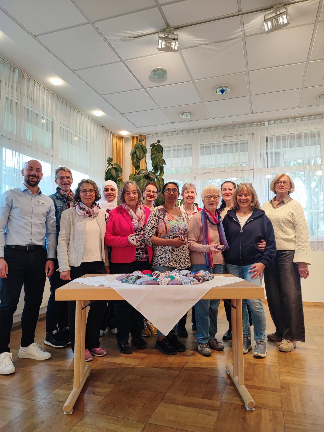 Im Rahmen der langjährigen Kooperation zwischen der Hospizgruppe Vaihingen an der Enz unter der Leitung von Frau Felicitas Benz und dem Karl-Gerok-Stift wurden heute handgefertigte „Handschmeichler“ an das Karl-Gerok-Stift übergeben. Die Geschenkstücke, gefertigt im Nähstübchen Enzweihingen, unterstützen die Bewohnerinnen und Bewohner bei der Sinnesanregung und beruhigender Begleitung. Das Nähstübchen wurde 2015 von Hildegard Bertsch ins Leben gerufen, als die ersten Geflüchteten nach Deutschland kamen. Bertsch fragte sich damals: „Was können wir für die Frauen tun?“ Gemeinsam mit dem ökumenischen Arbeitskreis Asyl sowie der katholischen und evangelischen Kirche entstand ein offenes Angebot, das Integration, Handwerk und Gemeinwohl verbindet. Stoffspenden ermöglichen das Projekt, der Inhalt der Handschmeichler stammt aus einer Spende der Vaihinger Mühle. Die kleinen, weichen Täschchen werden gezielt bei Bewohnerinnen und Bewohnern des Karl-Gerok-Stifts eingesetzt. Sie dienen als sinnliche Anregung, bieten taktile Stimulation und können bei unruhigem Verhalten, etwa beim typischen Bettnesteln, beruhigend wirken. Die Stücke sind handgefertigt und liebevoll verarbeitet. Am 18.05.2026 nahm Herr Nils Putze, Pflegedienstleitung und stellvertretende Hausdirektion des Karl-Gerok-Stifts, die Handschmeichler in Empfang. Herr Putze besichtigte das Nähstübchen und ließ sich die einzelnen Fertigungsschritte von Hildegard Bertsch zeigen. Sie leitet das das Projekt „Nähstübchen“ ehrenamtlich, organisiert und koordiniert. Das Nähstübchen wird weitere Handschmeichler anfertigen und dem Karl-Gerok-Stift regelmäßig Nachschub liefern. Stoffspenden sind stets willkommen; Interessierte werden gebeten, ihre Spenden vorher mit dem Nähstübchen im katholischen Gemeindehaus Enzweihingen abzustimmen.